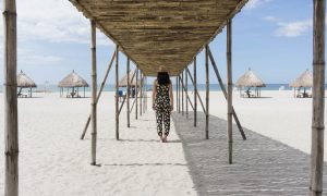 Caryl standing under the bamboo shade in Crystal Beach